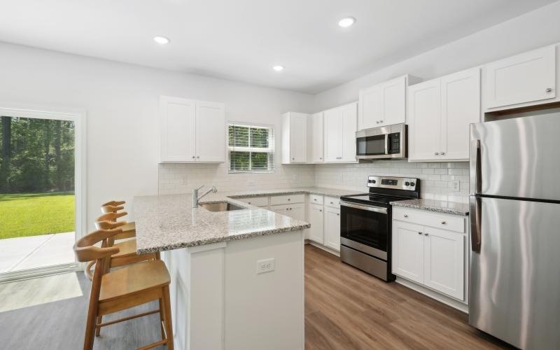 a kitchen with white cabinets