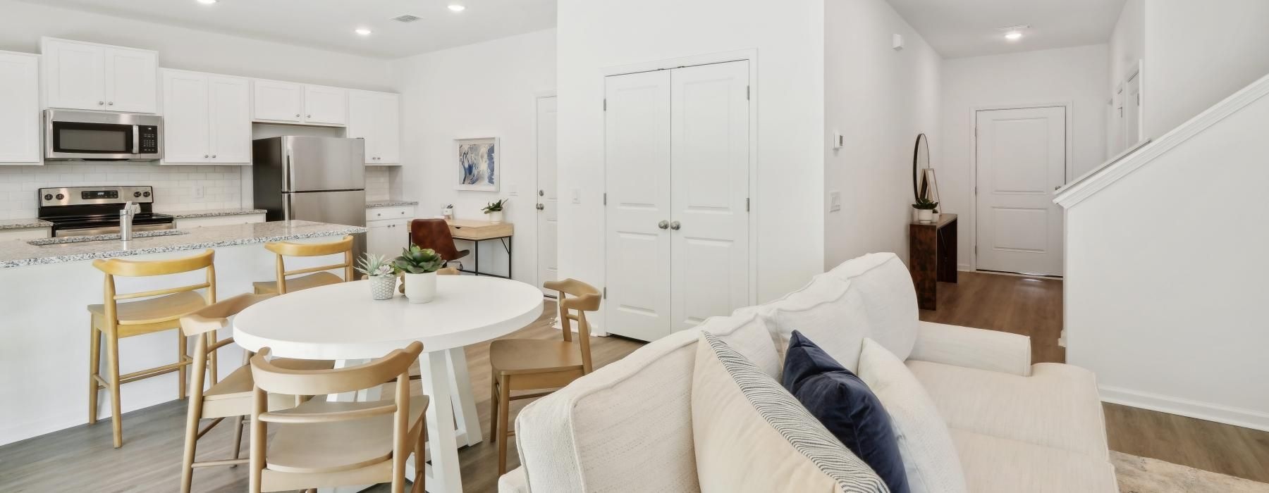 a large kitchen with a dining table and couches